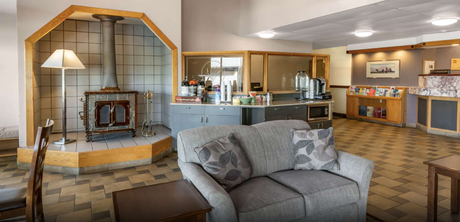 Sofa, woodstove, and coffee bar in a hotel lobby.